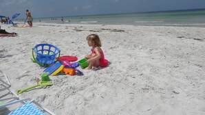 A sandy beach with a child playing with toys. - Key West Style Townhome  Intercoastal Waterviews!!!
 (Indian Rocks Beach)
