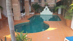 An indoor swimming pool with a tiled floor and a decorative fountain. - Heart Of Town,  Ocean Views, Pool, Walking Distance To Beach (Puerto Vallarata)