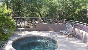 A circular hot tub with a metal ladder, surrounded by a concrete deck and metal railing. - Rare Ventana Canyon Intimacy,  Heated Pools, Tennis (Tucson)