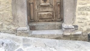 A stone building with a large wooden door, a stone archway, and a stone wall. - Idyllic Villa, with Infinity Pool, 4 air conditioned bedrooms  & stunning views. (Torino di Sangro)