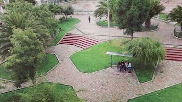 Stroll through this vibrant urban park surrounded by residential buildings and lush greenery.