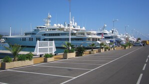 A marina with multiple yachts docked.