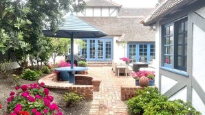 A courtyard with a brick pathway, outdoor seating, and a gazebo. - 4-bedroom vacation home just 12 minutes from LEGOLAND® California (Oceanside)