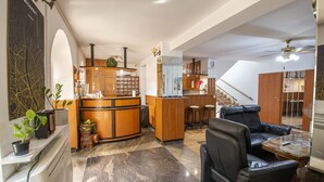 A spacious living area with a modern kitchen, a dining area, and a staircase leading to an upper level. - Richter Pansion (Budapest)