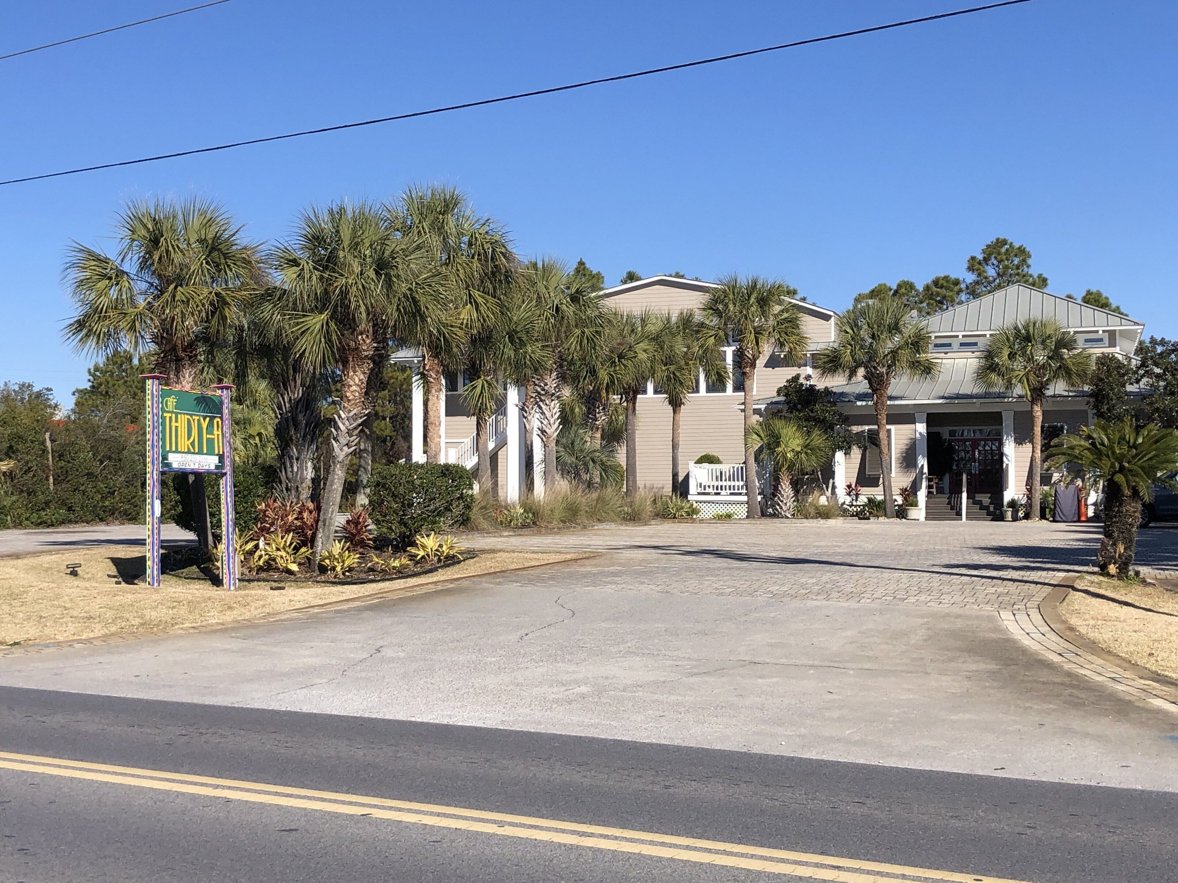 A hotel entrance with a sign indicating 'THIRTY-A' and 'OPEN 24 HOURS'.
