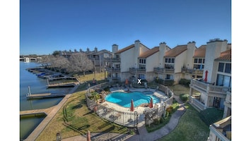 Aerial view of condo, swimming pool, and lake; X is our condo