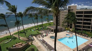 A hotel with a pool, beach view, and palm trees. - OceanFRONT, UPDATED, 4th Floor, 1BR Cali King, Non-Smoking, SHARP! (Kihei)