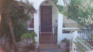 A white building with a black gate and a small entrance. - Beach House in a fantastic location With Stunning Views.  (algarve)