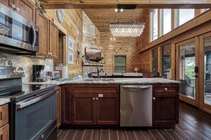Enjoy cooking in this well-equipped kitchen with a large island, microwave, oven, and dishwasher.