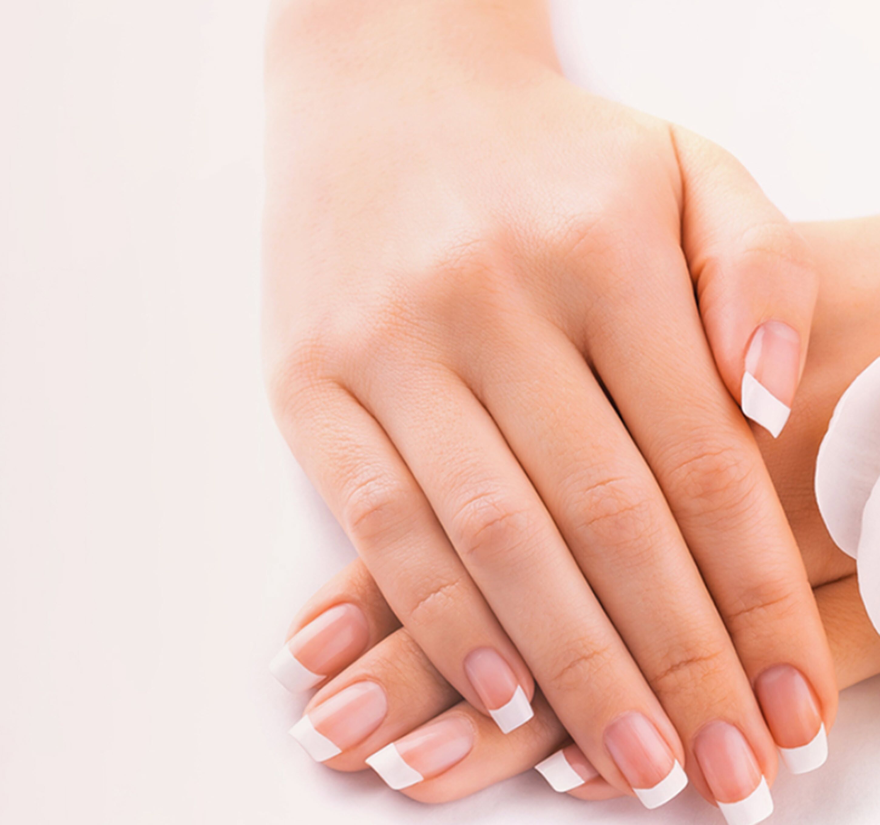 A close-up of hands with manicured nails.