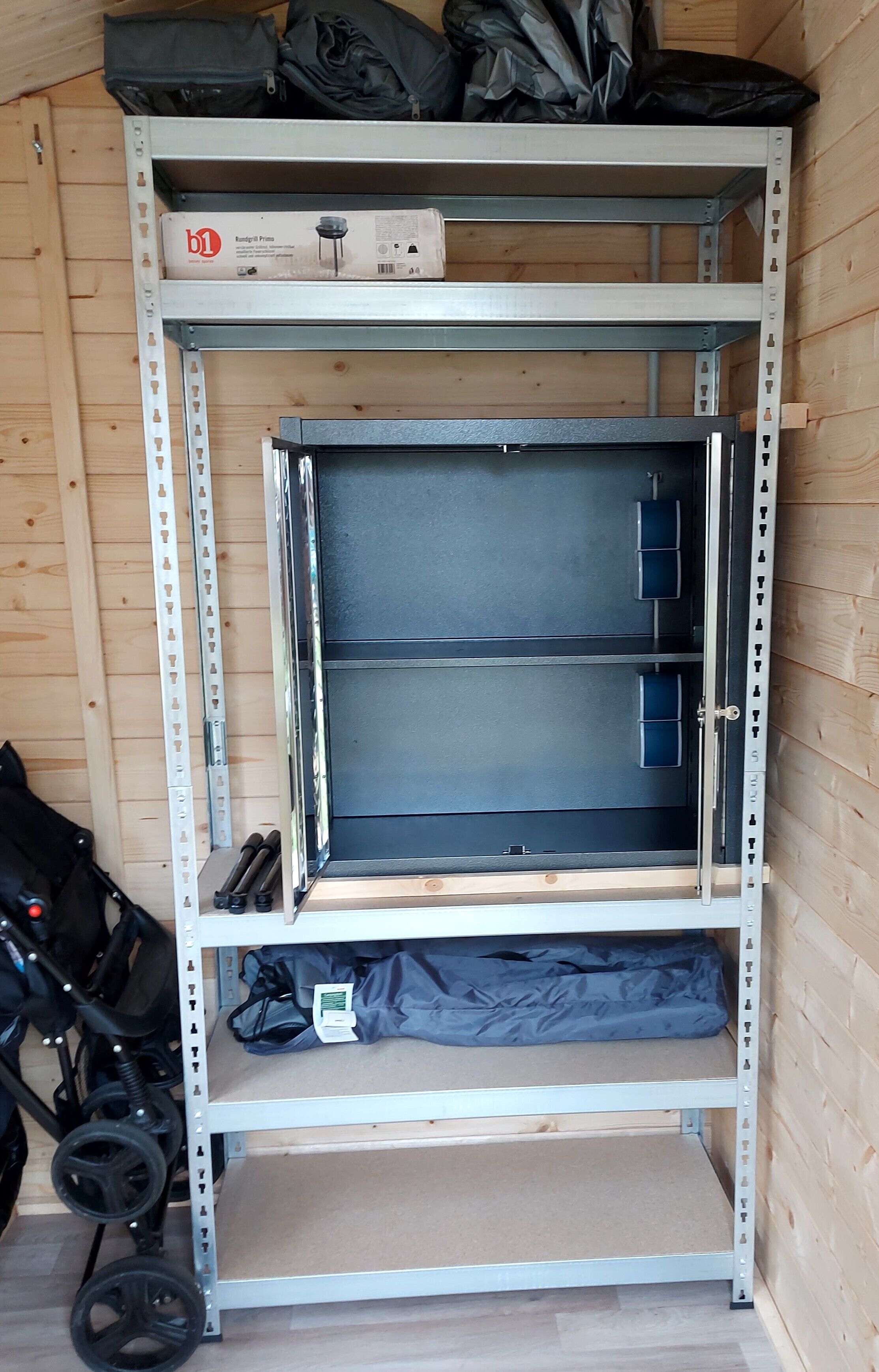 A metal shelving unit with a box labeled 'b1' on the top shelf.