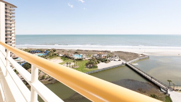 A high-rise building with a balcony overlooking a beach, a pier, and a small pool area. - 2BR/2BA Remodeled-All Rooms are Oceanfront! 12th Floor-2 Balconies-Beach Locker! (Myrtle Beach)