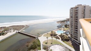 A high-rise hotel overlooking a beach with a swimming pool and a bridge. - 2BR/2BA Remodeled-All Rooms are Oceanfront! 12th Floor-2 Balconies-Beach Locker! (Myrtle Beach)