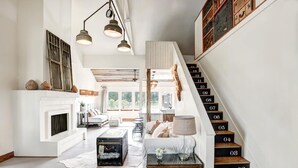 A spacious living area with a fireplace, a staircase with numbered steps, and a view of the outdoors. - ★ Seen in 250 Articles ★ 1min → Town ★ Private ★ Great Kitchen ★ Luxury Home ★ (Round Top)