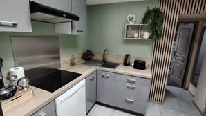 A modern kitchen with a dishwasher, stove, sink, and cabinets. - 50m2 of silence in the heart of Vitrolles (Vitrolles)