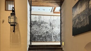 A staircase leading to a balcony with a view of a forest.