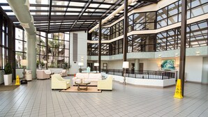 A spacious lobby with high ceilings, large windows, and multiple seating areas. - Phoenix VI #606 - Resort Style complex owner's Beach Chairs Included in Rental (Orange Beach)