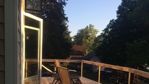 A wooden deck with outdoor furniture and a glass door leading to a covered area. - Deruyter lake waterfront  (Deruyter)