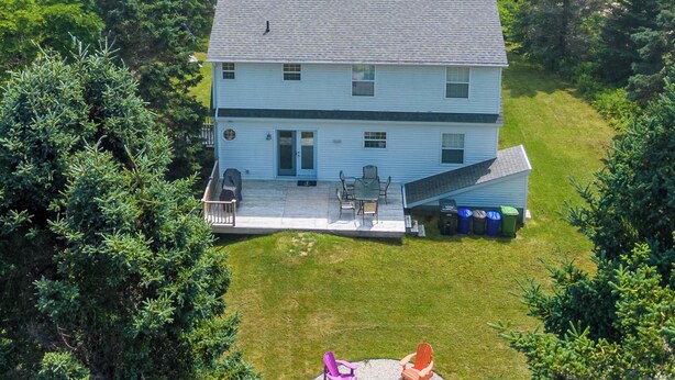 A two-story house with a deck overlooking a body of water. - Adventure Awaits at Salt & Tide Ocean Retreat (Hubbards)