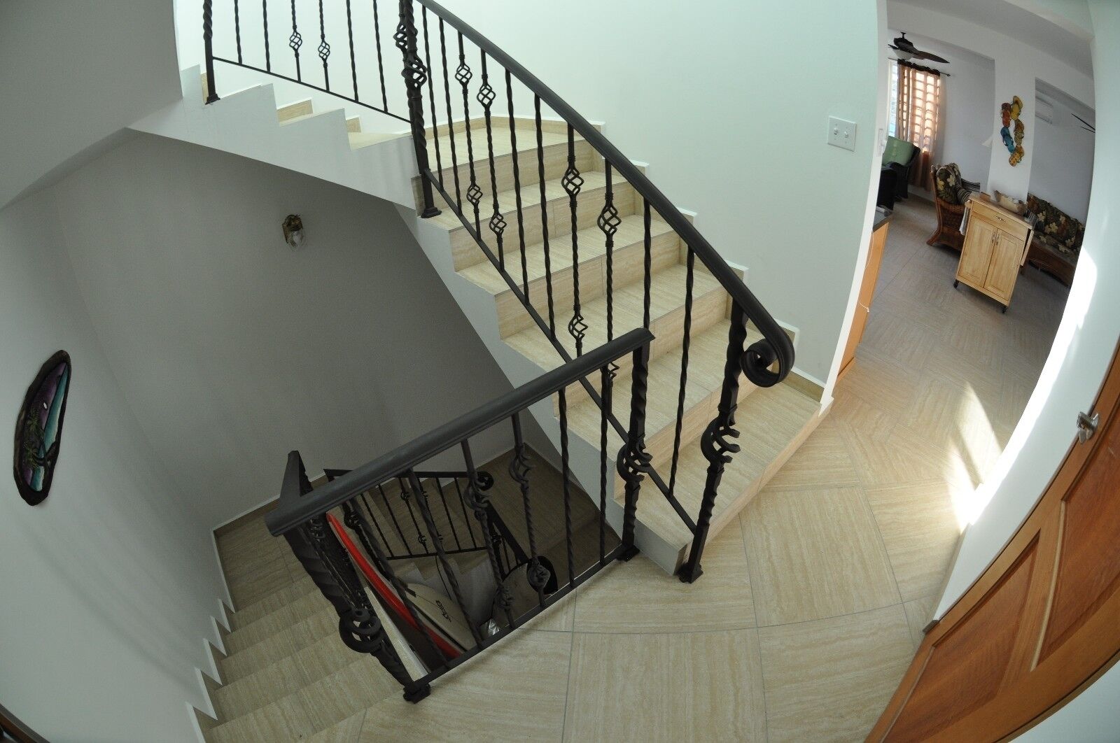 A staircase with black iron railings leading to a second floor.