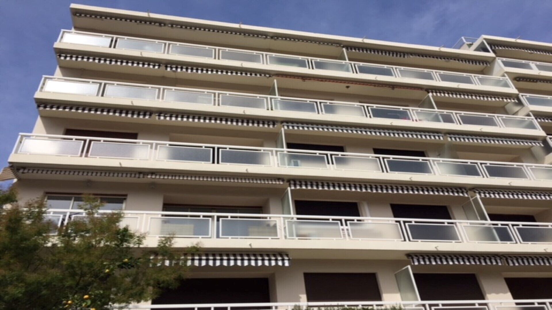 A multi-story building with balconies on each floor.