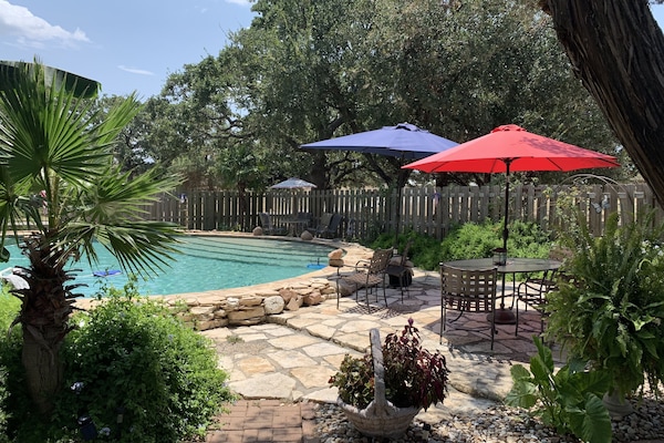 Tropical swimming pool . Possibly shared with two other rentals on property.