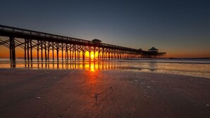 A pier extending into calm waters at sunset. - 2 Bedrooms with king beds and private bathroom for both. (Charleston)