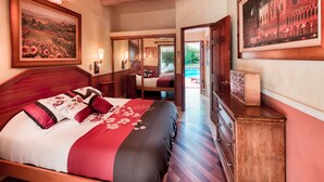 A bedroom with a large bed, wooden headboard, a ceiling fan, and a view of a pool through an open door.