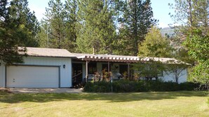 A single-story house with a garage, a covered porch, and a well-maintained lawn. - End of the road .... (Mariposa)