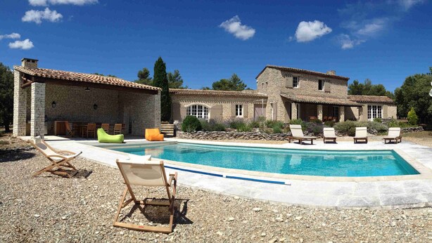 A pool area with lounge chairs and a stone building. - Gordes/Goult - Stunning Mas Provençal On A Hill In Luderon (Goult)