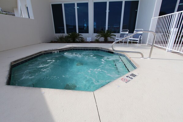 An indoor swimming pool with a tiled edge, a metal ladder, and a sign indicating a depth of 3 feet. - Lighthouse 308 - Beachfront with views! (Gulf Shores)