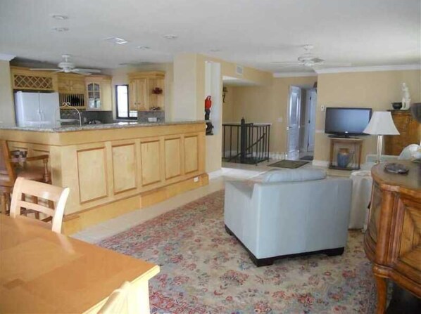 Relax in this spacious living area with a sofa, dining table, and kitchenette.