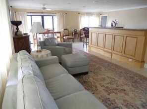 Relax in this inviting living space with a comfortable sofa, dining area, and kitchen.