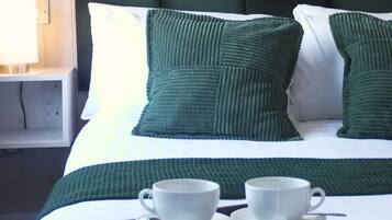 Desk, iron/ironing board, bed sheets