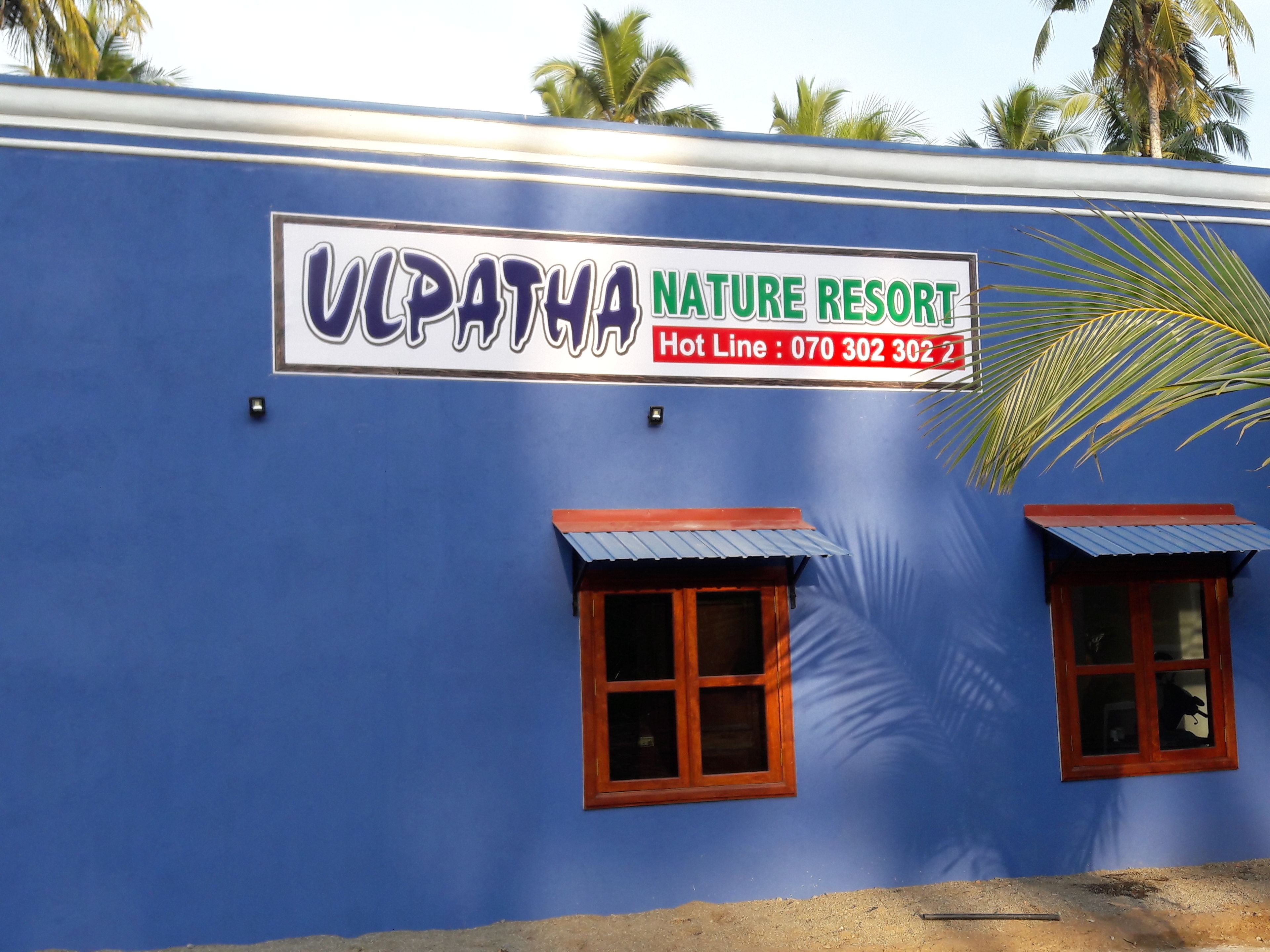 A building with a sign that reads "VCPATHA NATURE RESORT" and a hot line number.