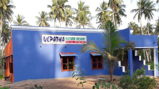 A building with a sign reading "UPATHA NATURE RESORT" and a contact number. - Ulpatha Nature Resort (Kobeigane)