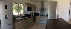 Enjoy cooking in this well-lit kitchen with a large window offering a view of the outdoors.
