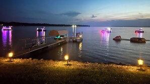 Un quai avec des bateaux, un espace abrité et une zone herbeuse avec un lampadaire.
