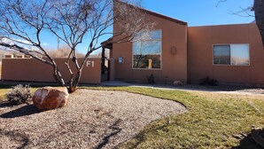 A modern building with a large window, a door, and a sign labeled "F1". - Moab Rim Village Oasis (Moab)