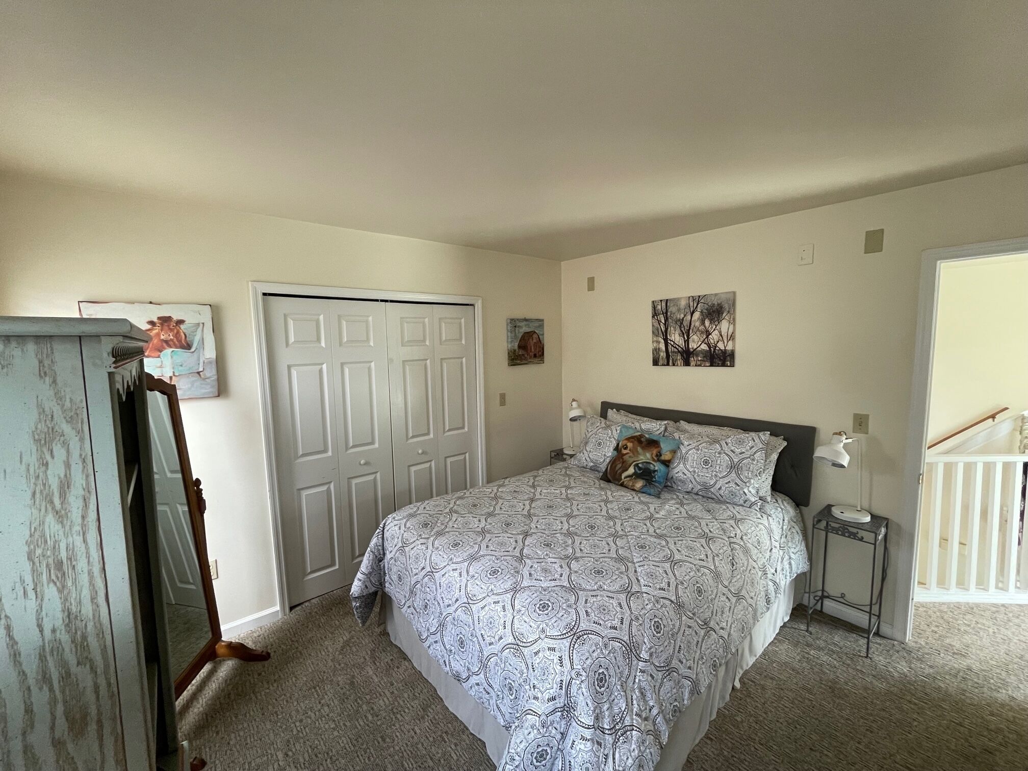 Ein Schlafzimmer mit Bett, Kleiderschrank, Schreibtisch und Stuhl.