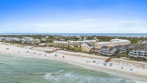 A coastal hotel with multiple buildings, a beach, and ocean views.