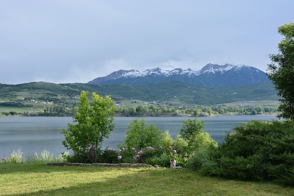 Spring backyard looking at Snow Basin ski resort and the lake.