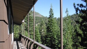 A wooden deck with a railing overlooking a forested mountain area. - Mountain Rustic Ski House Tahoe-Reno  Mt Rose-Snow Resort 1.5 Miles (Reno)