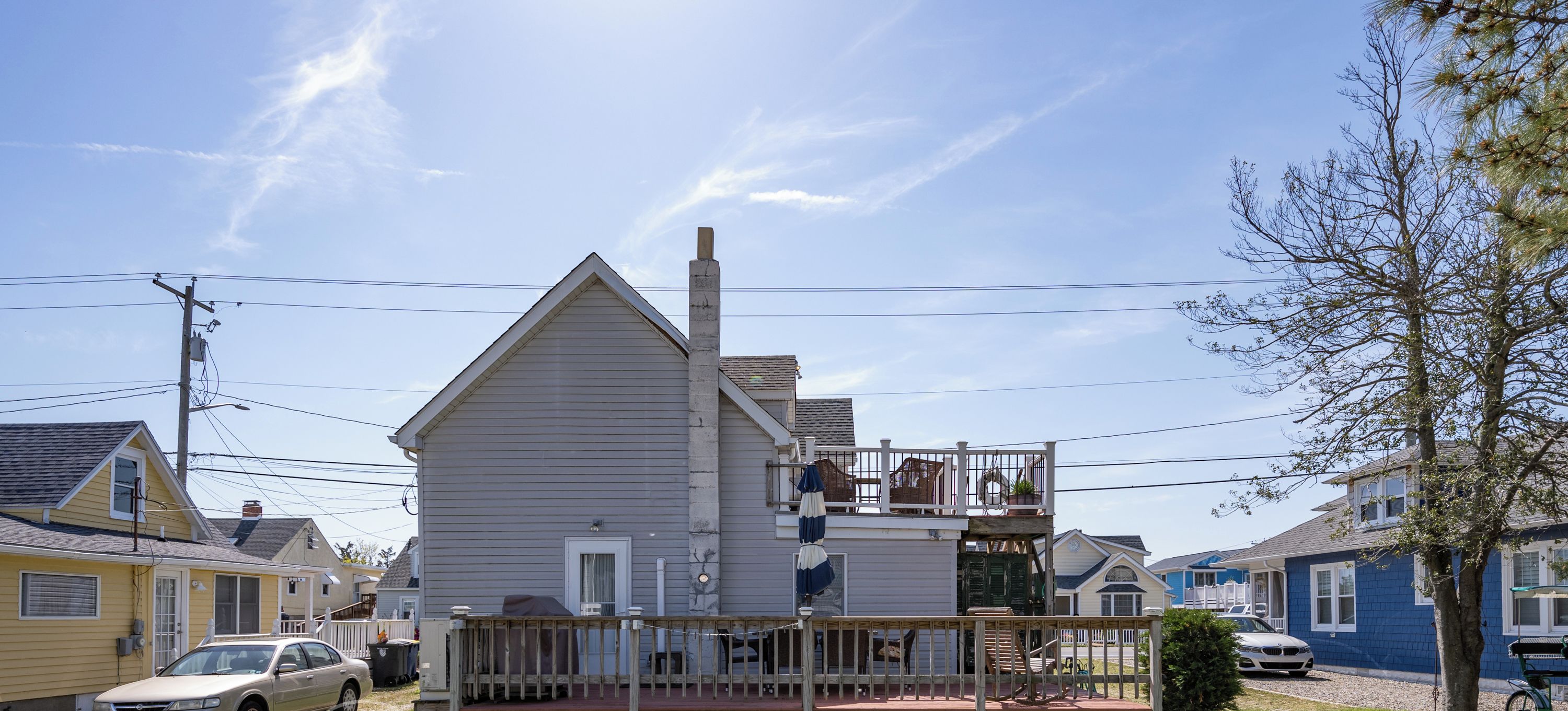A two-story house with a front porch, a garage, and a driveway.