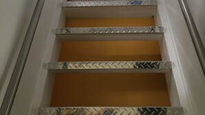 A staircase with metal handrails and a skylight above. - HIGH MOUNTAIN CONDO--PANORAMIC VIEWS! (Seven Devils)
