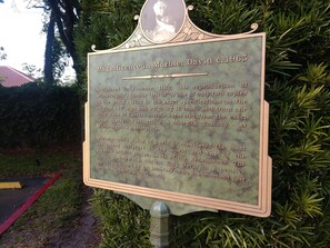 A historical plaque about Michelangelo's David sculpture, located outdoors with greenery around. - Direct Oceanfront & private, dog friendly, 2BR house, July/August availability. (St. Augustine)