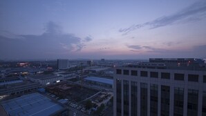 Panorama urbano al crepuscolo con edifici moderni e cielo sereno.