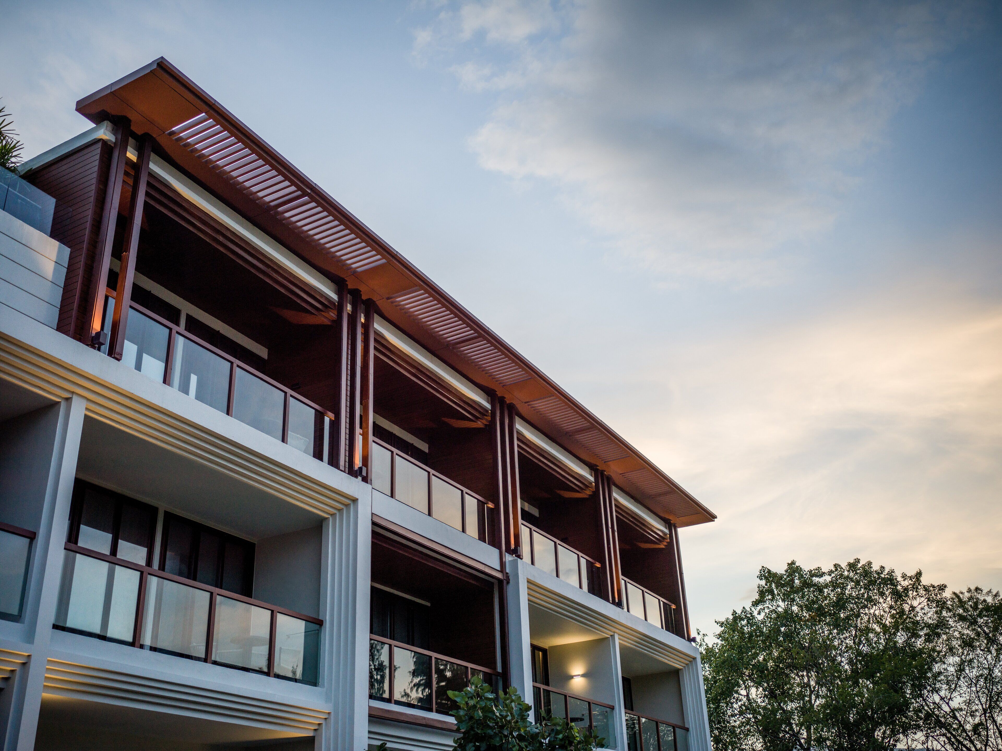 A modern multi-story building with large windows and balconies.
