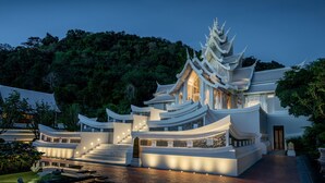 A traditional multi-tiered temple with a central staircase and a pond in the foreground. - InterContinental Phuket Resort by IHG (Kamala)