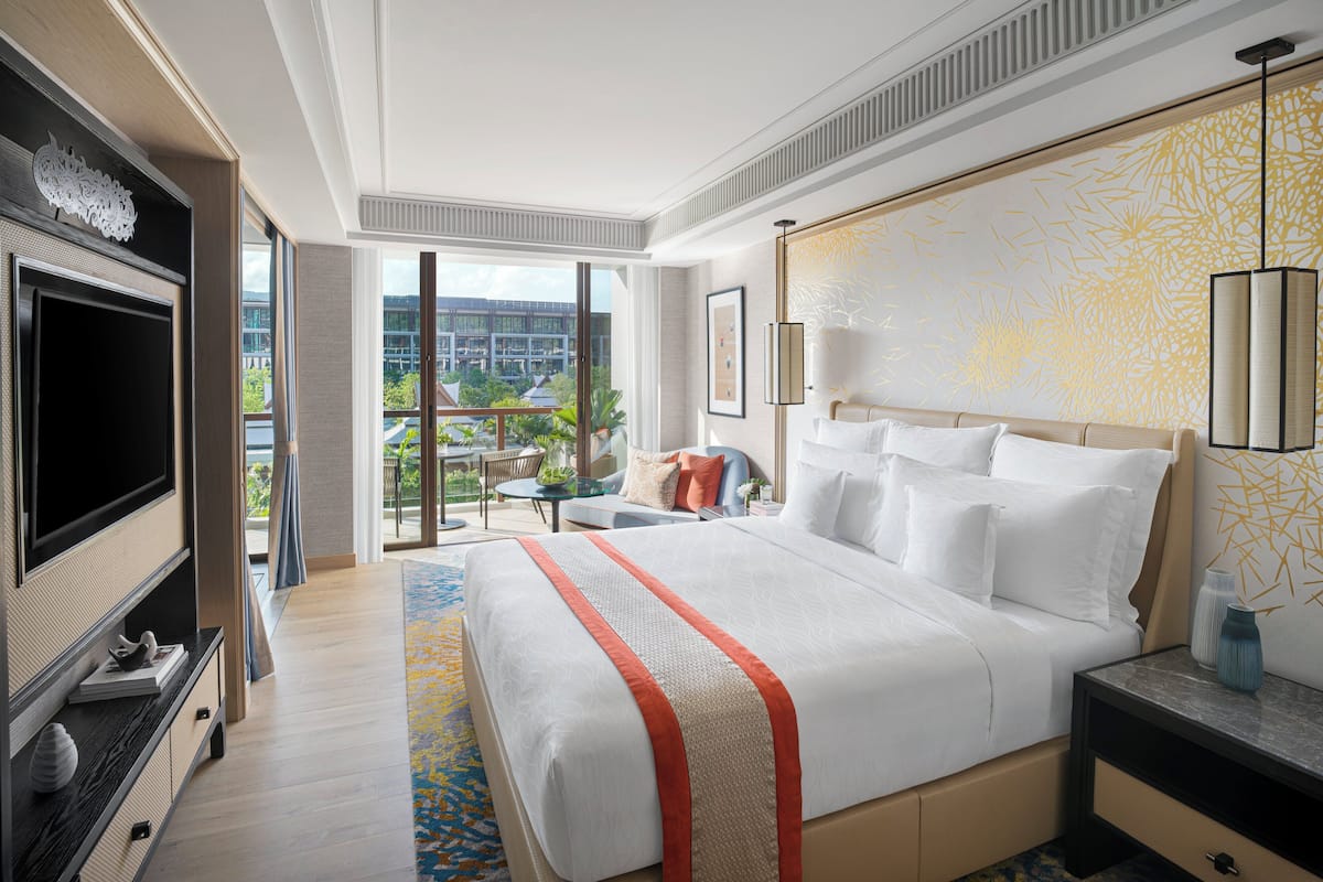 Relax in a spacious room with a large bed, flat-screen TV, and a view of the surrounding cityscape.
